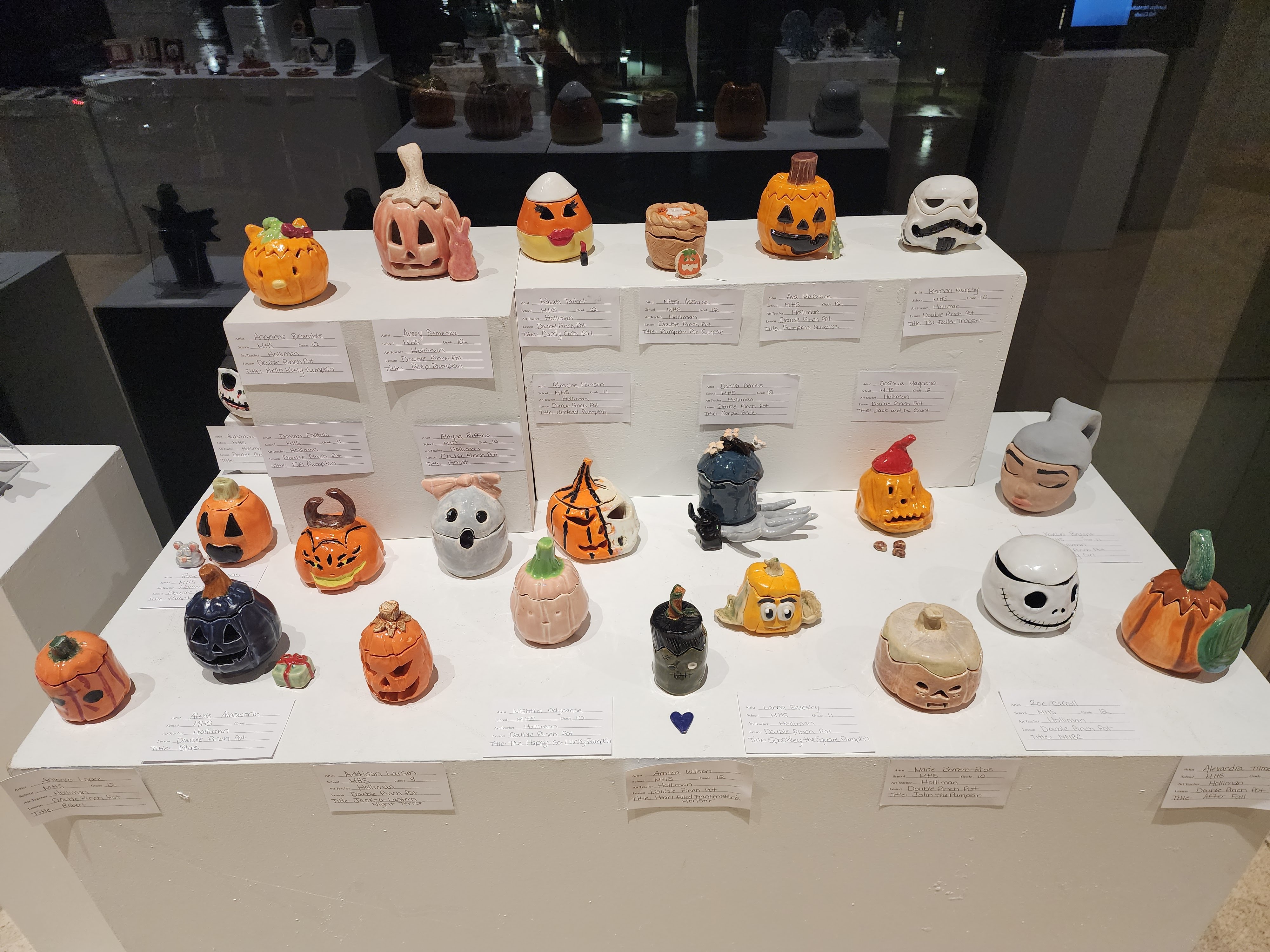 Pieces of student pottery on display in various Halloween themed shapes and designs